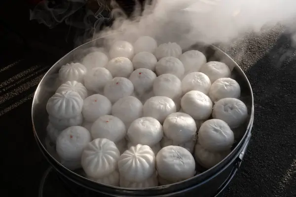 The steamed stuffed bun in the steamer in nature background.