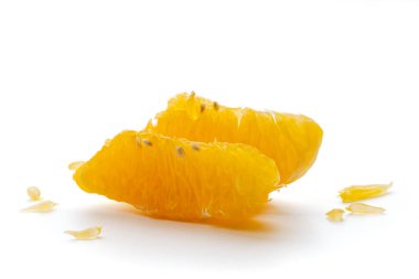 Peeled orange fruit pulp isolated on white background. Macro photo of citrus fruit slice. Fresh, juicy pulp of orange
