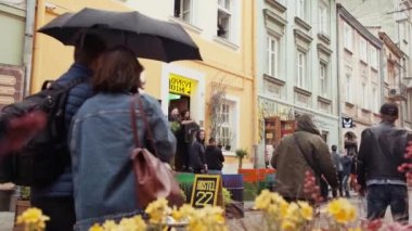 Old city crowdy street. European old town. Ukrainian city Lviv with street cafes and ancient buildings