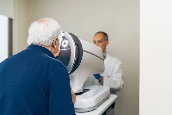 Medical expert administers precise laser therapy for glaucoma to an older patient.