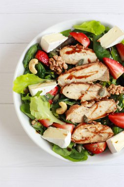 Çilekli tavuk salatası, taze sebze, fındık ve krema. Tavuk fileto, yeşillik, böğürtlen ve peynirli sağlıklı bahar salatası..