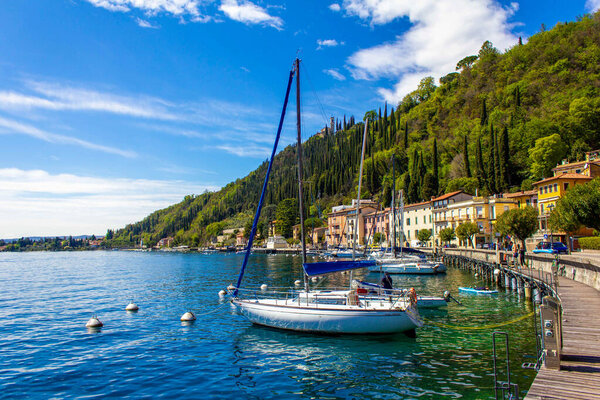 Wonderful view of yachts, boats and sailing boats in the harbor of Toscolano Maderno, Lago di Garda, Lombardy region, Italy, Europe