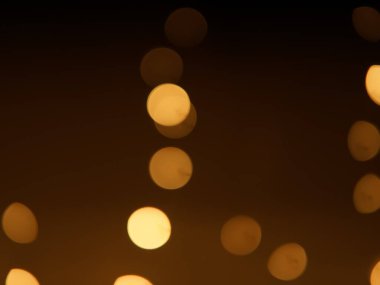 Altın ve koyu kahverengi Bokeh ışıkları şenlikli arka plan. Yüksek kalite fotoğraf