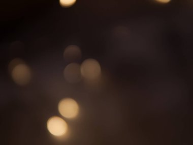 Altın ve koyu kahverengi Bokeh ışıkları şenlikli arka plan. Yüksek kalite fotoğraf
