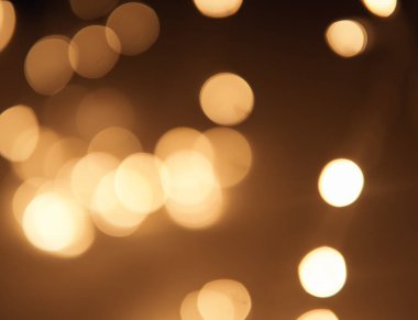 Altın ve koyu kahverengi Bokeh ışıkları şenlikli arka plan. Yüksek kalite fotoğraf