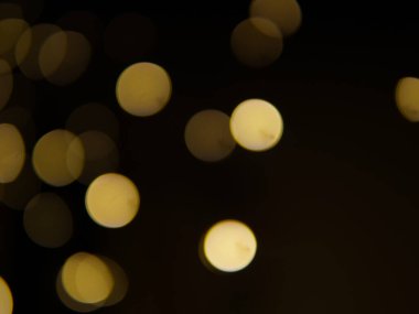 Altın ve koyu kahverengi Bokeh ışıkları şenlikli arka plan. Yüksek kalite fotoğraf