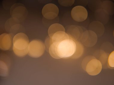 Altın ve koyu kahverengi Bokeh ışıkları şenlikli arka plan. Yüksek kalite fotoğraf