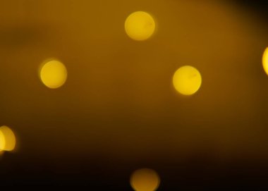 Altın ve koyu kahverengi Bokeh ışıkları şenlikli arka plan. Yüksek kalite fotoğraf