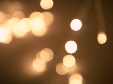 Altın ve koyu kahverengi Bokeh ışıkları şenlikli arka plan. Yüksek kalite fotoğraf