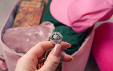 passport ,compass and pink backpack for tourist travel,packing clothes for the trip. High quality photo