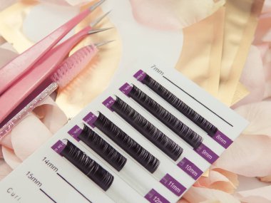 Close up of pallet with lashes on stick line for eyelash extensions, lash technician equipment for business . 