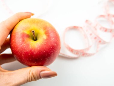 red apple and measure stripe on white background,diet concept.