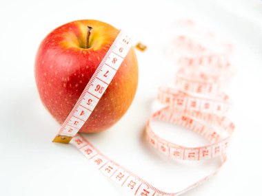 red apple and measure stripe on white background,diet concept.
