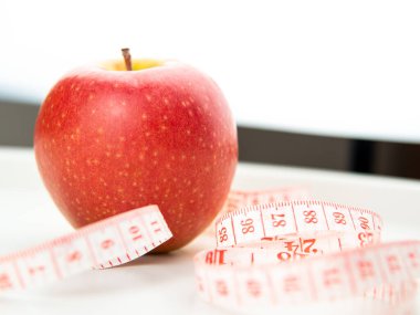 red apple and measure stripe on white background,diet concept.