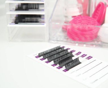 beauty salon equipment for eyelash extensions ,tools or lash technician white and pink colors.