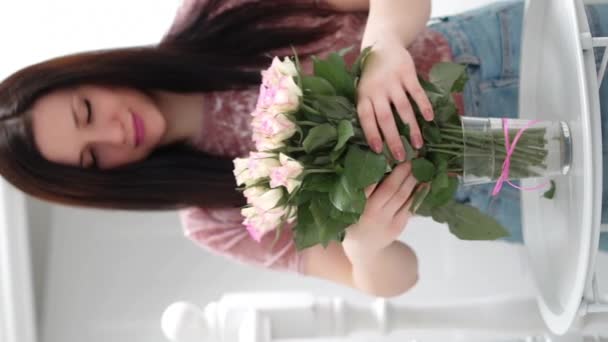 Μελαχρινή Έβαλε Ροζ Τριαντάφυλλα Στο Βάζο Κάθετο Βίντεο Υψηλής Ποιότητας — Αρχείο Βίντεο