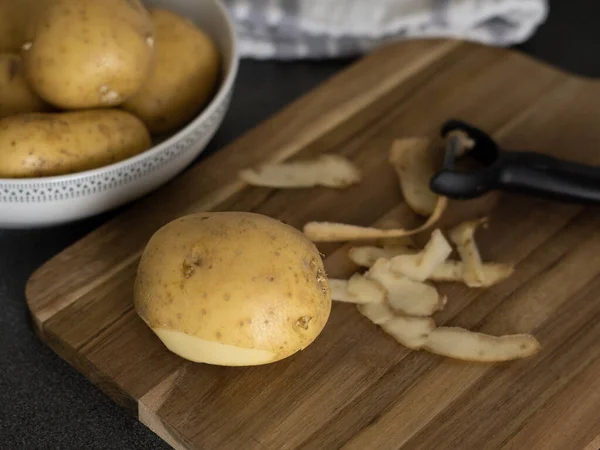 stock image raw potatoes with peeled skin on the wooden desk on the table. High quality photo