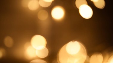 Zengin kahverengi bokeh arka plan, sıcaklığı ve zarafeti çağrıştırıyor, tasarıma derinlik ve entelektüellik katmak için mükemmel.