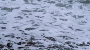 Kasvetli bir günde fırtınalı bir denize düşen dalgaların videosu. Yüksek kalite 4k görüntü