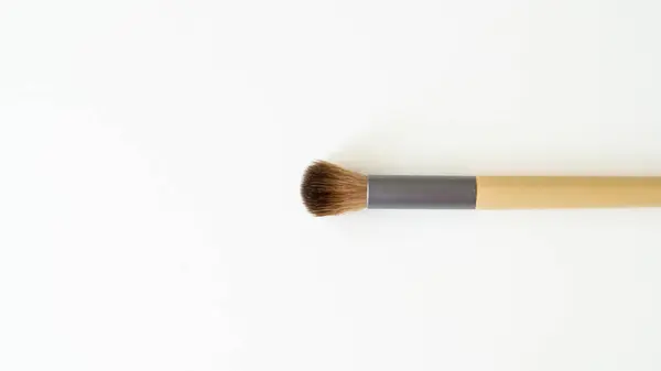 stock image Wooden organic makeup brushes on white backdrop. Eco-friendly, sustainable beauty tools.
