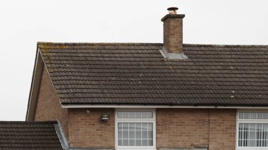 Traditional English house brick roofs, suburban area. clipart