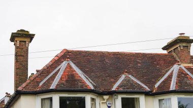 Traditional English house brick roofs, suburban area. clipart