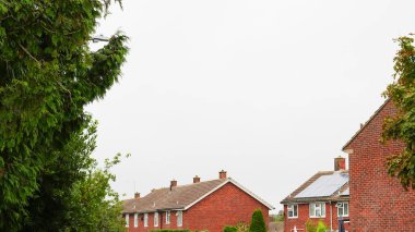 Traditional English house brick roofs, suburban area. clipart