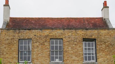 Traditional English house brick roofs, suburban area. clipart