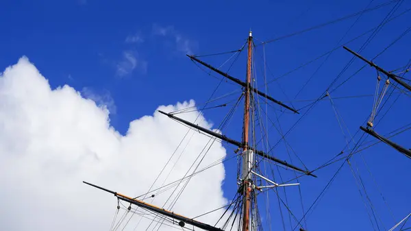 stock image Shkots, halyards, and braces against blue sky, shipbuilding elements in focus