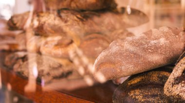 Taze pişmiş ekmek sokak vitrininde sergileniyor, altın hamuru cezbediyor..