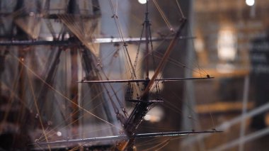 Ship models in maritime museum, displaying sailing history and shipbuilding details.. clipart