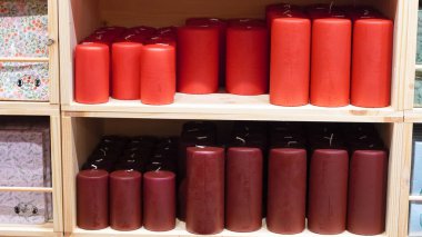 Display of candles on a showcase, arranged for sale in a cozy store setting. clipart