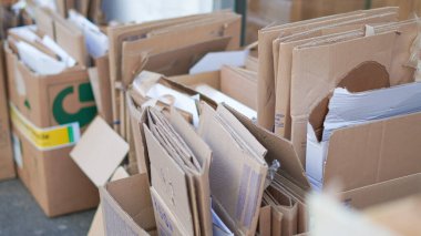 Compressed cardboard bundles outside, sorted and ready for waste recycling clipart