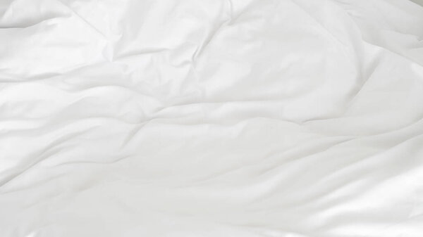 White duvet and pillow on cozy bed showing hotel calm and spa ambiance.