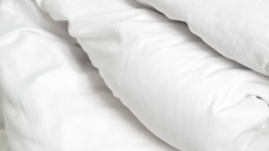 Yatağın üzerindeki yumuşak beyaz yorgan otel konforunu ve huzur dolu dinlenme yerini simgeliyor..