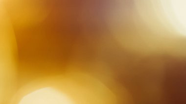 Altın kahverengi tonlu ve rahatlatıcı bulanık tarzlı soyut sinematik bokeh..