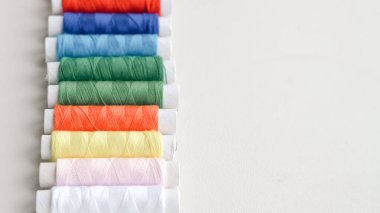 DIY için iplikler, iğneler ve mezura da dahil olmak üzere düz dikiş araçları yatar.