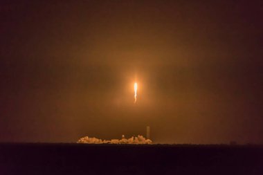 CAPE CANAVERAL, FLORIDA - 15 MARCH 2024. Evening launch of the FALCON 9 rocket as seen from Titusvile from Indian River. A rocket carrying a set of satellites into orbit, Elon Musk's company SpaceX. clipart