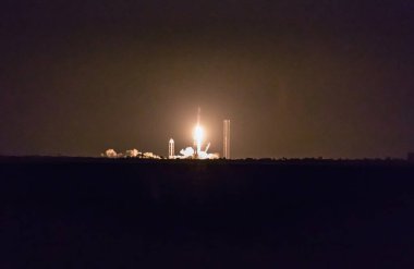 CAPE CANAVERAL, FLORIDA - 15 MARCH 2024. Evening launch of the FALCON 9 rocket as seen from Titusvile from Indian River. A rocket carrying a set of satellites into orbit, Elon Musk's company SpaceX. clipart
