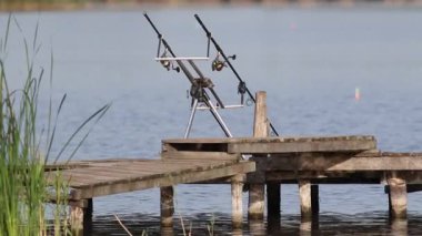 Sabahın erken saatlerinde, balıkçılık malzemeleri ve çubuklar nehir kıyısındaki bir balıkçı köprüsüne kurulur.