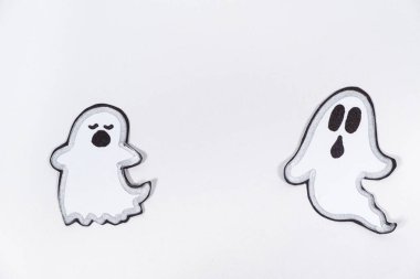 Beyaz arka planda yüzleri olan sevimli hayaletler..