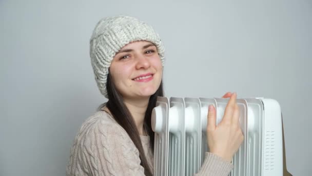 Brunette Woman Hat Hugs Oil Heater Warms Winter — Stock Video