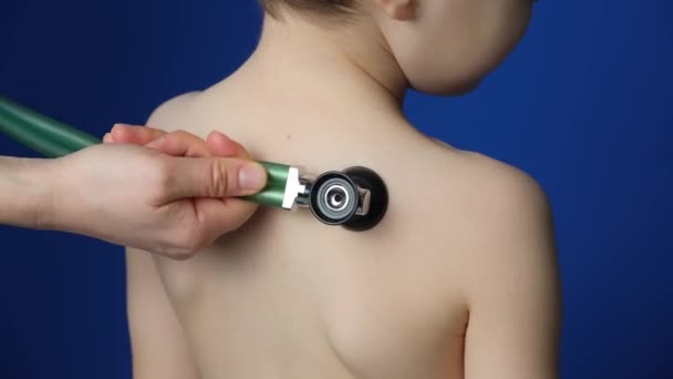 Doctor Examines Child Stethoscope Listens Heartbeat Breathing Blue Background Close — Stock Video