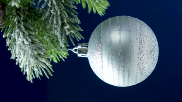 Shiny White Ball Spins Snow Covered Christmas Tree Vertical Video — 图库视频影像