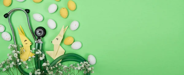 Happy and healthy Easter - medical banner with stethoscope, Easter bunny and eggs, place for text.