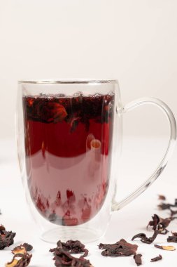 Red hibiscus tea from the petals of the Sudanese rose in a glass cup with a double bottom.
