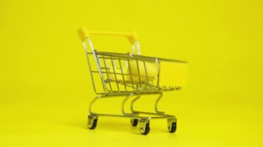 Easter Sale - Yellow Painted Eggs Fall Into The Shopping Cart.