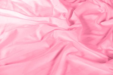 Abstract pink fabric background, satin stripe texture, wavy folds of elegant expensive fabric.