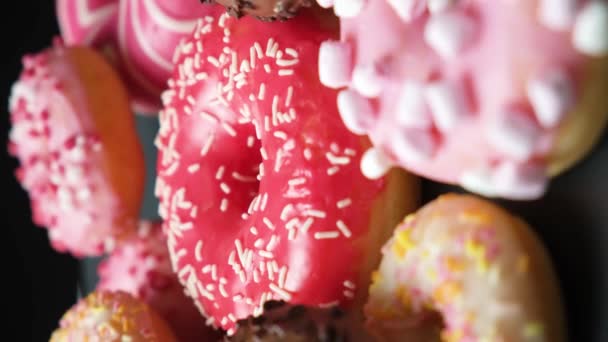 ピンク チョコレートアイシングとマシュマロのドーナツは 上からの眺めを回転させます — ストック動画