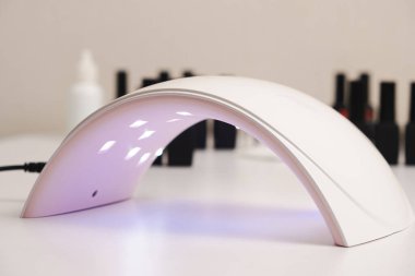 Ultraviolet LED lamp for drying gel nail polish and jars with gel polishes. Manicure and pedicure
